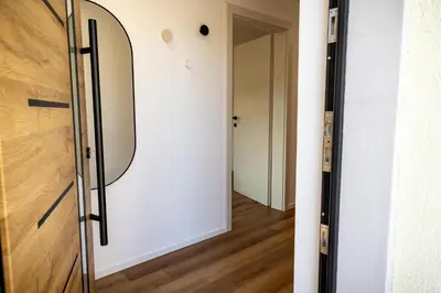 a hallway with a door with a mirror on it at Hidden Corner in Žirovnica