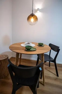 a wooden table with two bowls on it with two chairs at Hidden Corner in Žirovnica