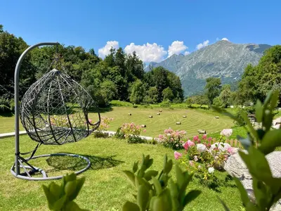 a sculpture in a field with a herd of animals at Cozy & Chic - Apartment with a private patio in Kobarid
