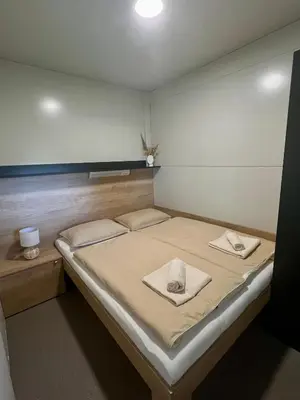 a bed in a room with two towels on it at ChillHouse in Ajdovščina