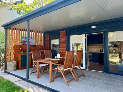 a house with a table and chairs on a patio at ChillHouse in Ajdovščina