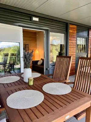 a wooden table with two plates on top of it at ChillHouse in Ajdovščina