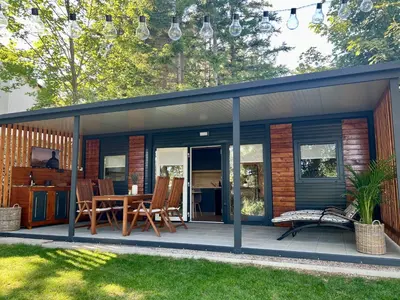 a house with a deck with a table and chairs at ChillHouse in Ajdovščina