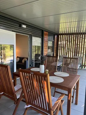 a porch with a wooden table and chairs at ChillHouse in Ajdovščina