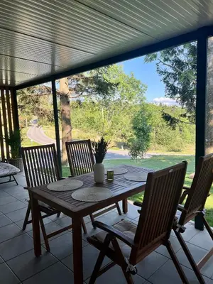 a wooden table and chairs on a patio at ChillHouse in Ajdovščina
