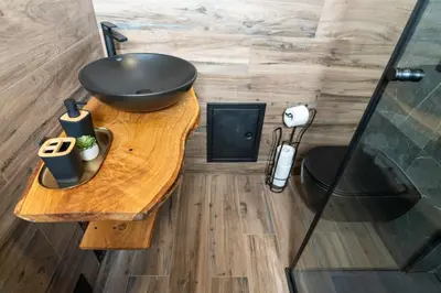 a bathroom with a sink on a wooden table at Apartmaji Lipa in Bohinj