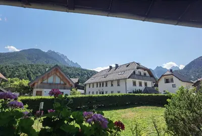a view of a village with mountains in the background at Apartma Žerjav in Kranjska Gora
