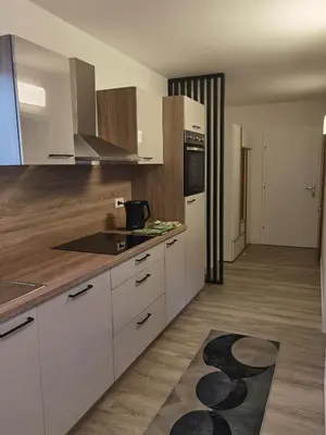 a kitchen with white cabinets and a counter top at Apartma Žerjav in Kranjska Gora