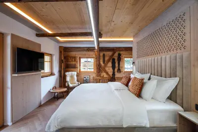 a bedroom with a large bed and a tv at Hotel Julian Alps in Zgornje Gorje
