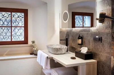 a bathroom with a sink and a bath tub at Hotel Julian Alps in Zgornje Gorje