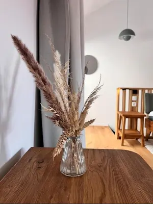 a vase with feathers in it sitting on a table at Up and above in Kobarid
