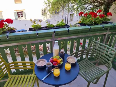 a table with a bowl of fruit and a bottle of milk at Up and above in Kobarid
