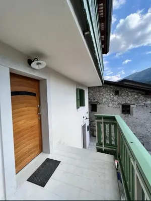 a wooden door on the side of a house at Up and above in Kobarid