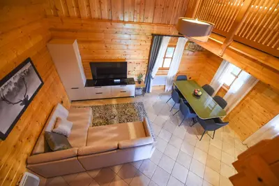 an overhead view of a living room with a couch and a table at Wooden Cottage Baznik with Hot Tub in Cerklje ob Krki