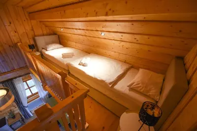an overhead view of a bedroom in a log cabin at Wooden Cottage Baznik with Hot Tub in Cerklje ob Krki
