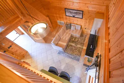 an overhead view of a living room with a couch at Wooden Cottage Baznik with Hot Tub in Cerklje ob Krki