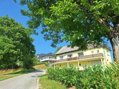 a large yellow house on a road at Rural Retreat- Kmečki oddih in Poljčane
