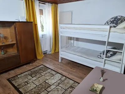a room with two bunk beds and a table at Rural Retreat- Kmečki oddih in Poljčane