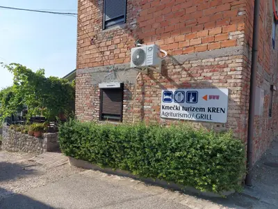 a sign on the side of a brick building at Agritourism Kren in Dobrovo