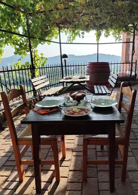 a wooden table with plates of food on it at Agritourism Kren in Dobrovo
