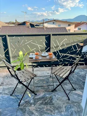 a table and chair on a balcony with a table at Apartment Emona in Ljubljana
