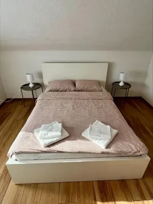 a bed with two pillows on it in a bedroom at Apartment Emona in Ljubljana