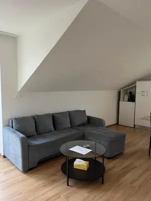 a living room with a couch and a table at Apartment Emona in Ljubljana