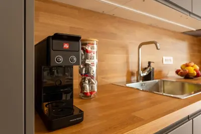 a kitchen with a coffee maker on a counter at Apartmaji Klavdija in Ljubljana