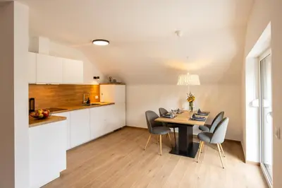 a kitchen and dining room with a table and chairs at Apartmaji Klavdija in Ljubljana