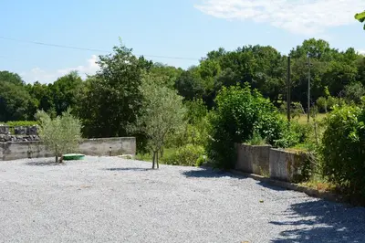 a parking lot with trees and a wall at Vila Borealis in Komen