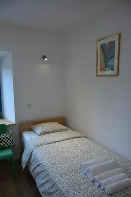two beds sitting next to each other in a bedroom at Vila Borealis in Komen