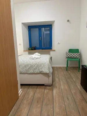 a bedroom with a bed and a blue window at Vila Borealis in Komen