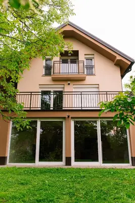 a building with a balcony and large windows at Apartma RO-ZE in Bistrica ob Sotli