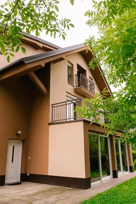 a house with a balcony on the side of it at Apartma RO-ZE in Bistrica ob Sotli