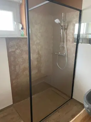 a shower with a glass door in a bathroom at Janko's house in Maribor