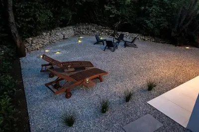 a patio with two picnic tables and two chairs at Private House - Serenity home in Lokev