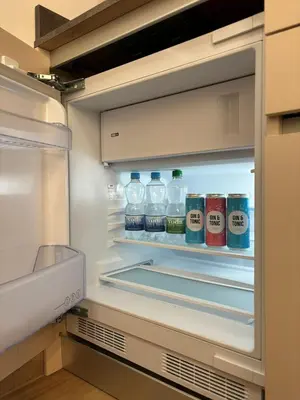 an open refrigerator filled with water and sodas at Private House - Serenity home in Lokev