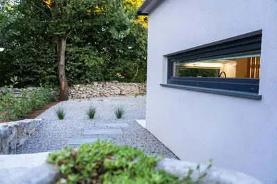 a building with a window on the side of it at Private House - Serenity home in Lokev