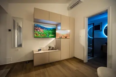 a living room with a desk and a painting on the wall at Private House - Serenity home in Lokev