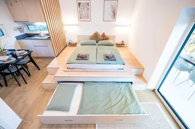 a room with two beds in the middle of it at Private House - Serenity home in Lokev