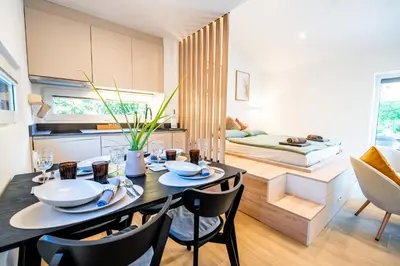 a kitchen and dining room with a table and chairs at Private House - Serenity home in Lokev