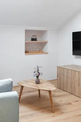 a living room with a coffee table and a tv at Wellba Homestead Planina in Ajdovščina