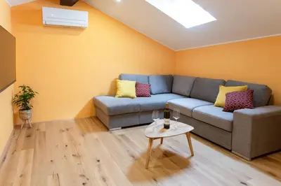 a living room with a couch and a table at Wellba Homestead Planina in Ajdovščina