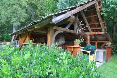 a small wooden house with plants in a garden at Vila Edelweiss Rooms&App Kranjska Gora in Kranjska Gora