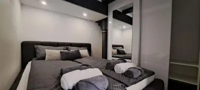 a bedroom with a large bed and a mirror at Ljubljana Nest- centre, free parking- renovated August 2024 in Ljubljana