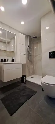 a bathroom with a toilet and a sink and a shower at Ljubljana Nest- centre, free parking- renovated August 2024 in Ljubljana