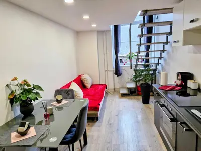 a living room with a red couch and a table at Ljubljana Nest- centre, free parking- renovated August 2024 in Ljubljana