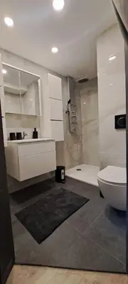 a bathroom with a toilet and a sink and a shower at Ljubljana Nest- centre, free parking- renovated August 2024 in Ljubljana