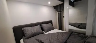 a bedroom with a bed and a mirror at Ljubljana Nest- centre, free parking- renovated August 2024 in Ljubljana