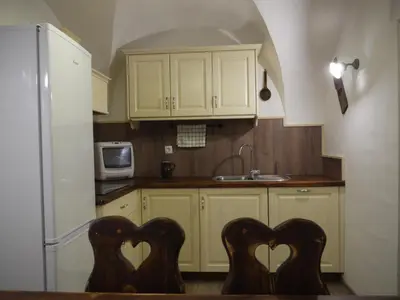 a kitchen with two hearts on the backs of two chairs at Apartments Petacova Hiša in Kranjska Gora
